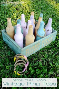 a wooden box filled with empty bottles sitting in the grass