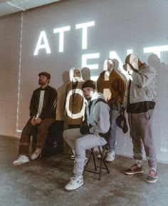 five people standing in front of a sign that reads at & t e n o