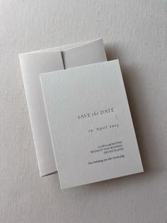 two wedding save the dates cards on top of each other