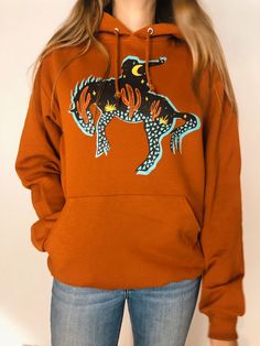 Midnight Cowboy Hoodie - Rusty Orange – Cactus Cowgirl Boutique Cowgirl Boutique, Cowboys Hoodie, Midnight Cowboy, Rusty Orange, Orange Hoodie, Exclusive Designs, Hooded Sweatshirt, Hooded Sweatshirts, Cactus