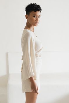 Twist it, tie it, make a loose bow or wear it off shoulder - options are endless with our sensual, multiple style Ramie Wrap Top. This top features a flowy, bell shaped full-length sleeve, and wrap tie waist which gives an ever so soft and feminine silhouette tailored to your unique body shape. Ramie is a smooth and quick drying natural fiber first used in ancient Egyptian times, and in Europe during the Middle Ages - so it’s safe to say it has stood the test of time. We love Ramie because of it Spring Tie Back Wrap Top, Spring Wrap Top With Tie Back, Elegant Beach Top With Tie Back, Chic Tied Blouse For Summer, Elegant Tie Back Top For Beach, Elegant Tie-back Tops For The Beach, Chic Wrap Blouse With Tie Sleeves, Chic Summer Tied Blouse, Chic Wrap Top For Day Out