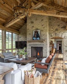 a living room filled with lots of furniture and a fire place in the middle of it