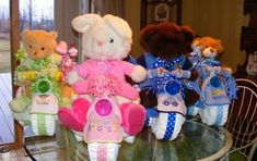 a group of stuffed animals sitting on top of a glass table