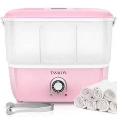 a pink toaster with two rolls of white towels next to it