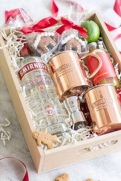 a wooden box filled with drinks and cookies