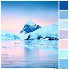 an iceberg is seen in the distance with blue and pink hues on it