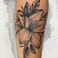 a black and white flower tattoo on the leg