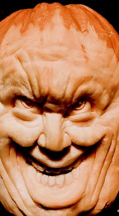 a carved pumpkin with an evil face on it