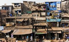 a group of people walking around a slum city