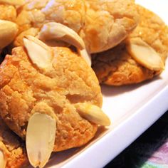 cookies with almonds are on a white plate