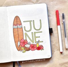 an open notebook with the word june written in it and some markers next to it