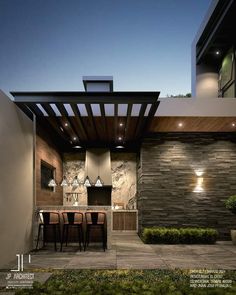 an outdoor kitchen and dining area is lit up at night with lights on the ceiling