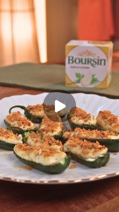 an image of stuffed peppers on a plate with box of boursin in the background