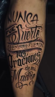 a man's leg with some writing on it and the words in different languages