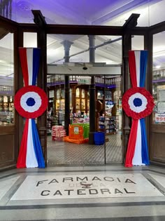 an entrance to a store decorated with red, white and blue ribbons