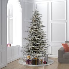 a white christmas tree with presents under it