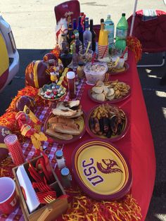 a picnic table with food and drinks on it