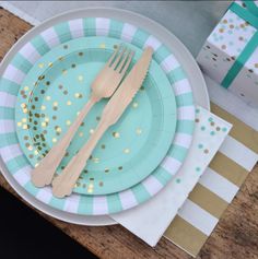 there is a plate with gold dots on it and a fork next to the plate