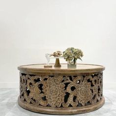 an ornate wooden table with flowers on top