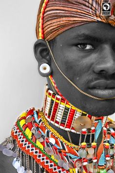 an african man with colorful jewelry on his face