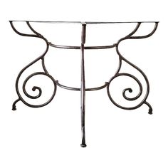 a metal table with an ornate design on it's top and bottom part, against a white background