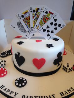 a birthday cake with playing cards on top