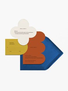 three different colored envelopes sitting on top of each other