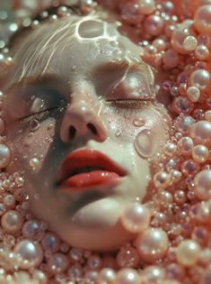 a woman's face is surrounded by pearls