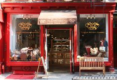 a red store front with many items in the window