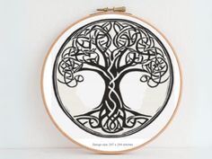 a cross stitch pattern with a tree of life on it's hoop - frame