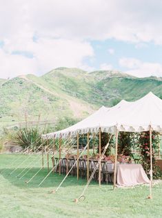 an outdoor tent set up with tables and chairs