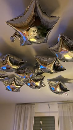 several shiny objects are hanging from the ceiling