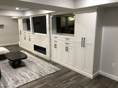 a living room filled with furniture and a flat screen tv mounted to the side of a wall