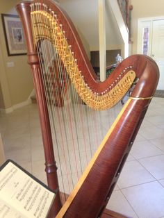 a large wooden harp sitting on top of a hard wood floor