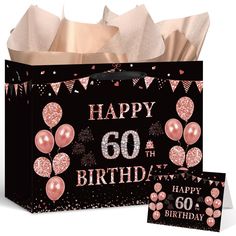 a birthday gift bag with pink balloons and confetti on the front, next to a card that says happy 60th birthday