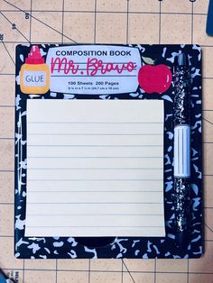 a composition book with writing paper and markers