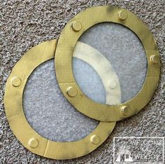 two brass portholes are sitting on the carpet