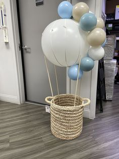 some balloons are in a basket on the floor