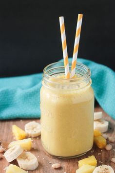 a jar filled with banana and pineapple smoothie