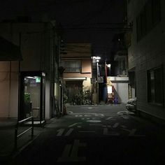 an empty street at night with no cars on it