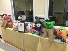 there are many stuffed animals sitting on the table together in front of the window,