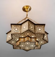 an intricately designed light fixture hangs from the ceiling