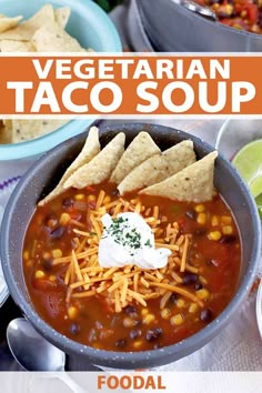 two bowls of chili with tortilla chips and sour cream on the rims