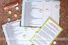 three children's question cards on top of a table with candy and candies