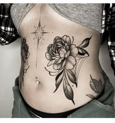 a woman's stomach with flowers and stars on the side, in black and white