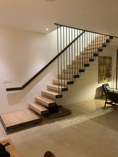 a living room filled with furniture and a stair case