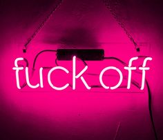 a neon sign that says fuk off on it's side hanging from the wall