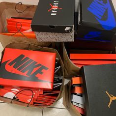 many nike boxes are stacked on top of each other