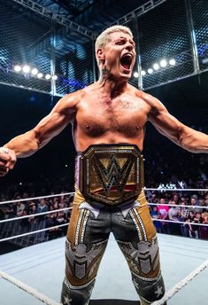 a man standing on top of a wrestling ring