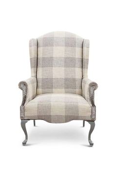 an upholstered chair with a plaid pattern on the back and arms, sitting in front of a white background